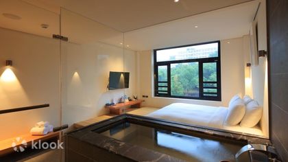 A Beitou hotel room with its own sunken thermal tub beside the window