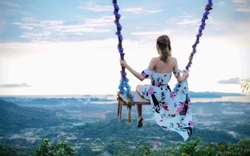 Girl on big swing