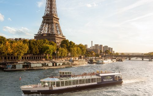 Cruise past the Eiffel Tower aboard the Paris en Scene dinner boat at sunset"