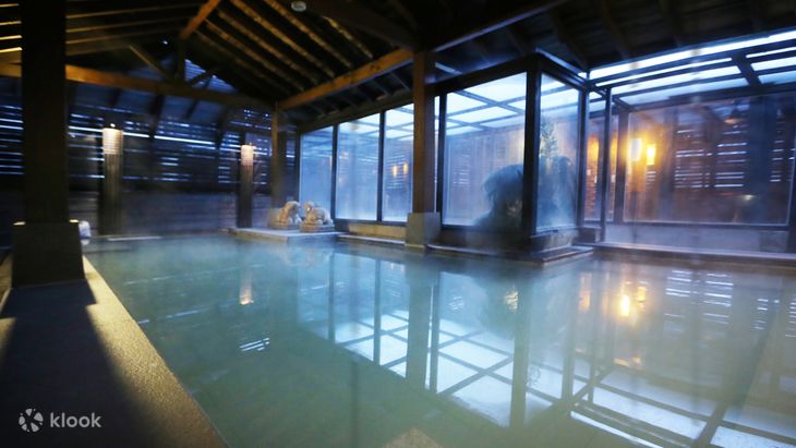 The glass-walled indoor thermal pool at Shan Yue Hot Spring Resort