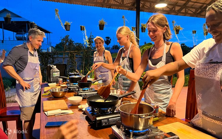 Visitors preparing Cambodian dishes during a cooking class