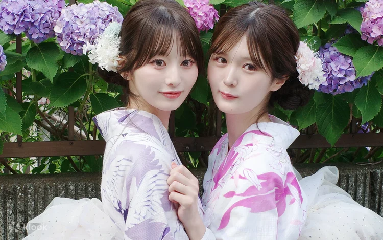 Two people in rental kimono standing in front of hydrangeas