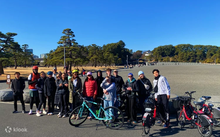 Tour riders with their bicycles on the plaza in front of the Imperial Palace