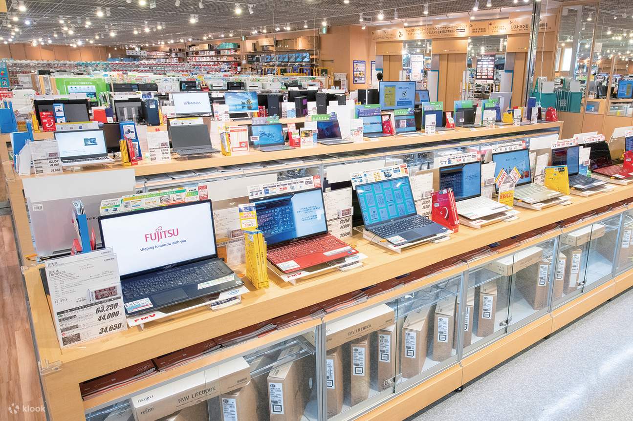 Yamada Denki customer service representative assisting shopper with Japanese electronics