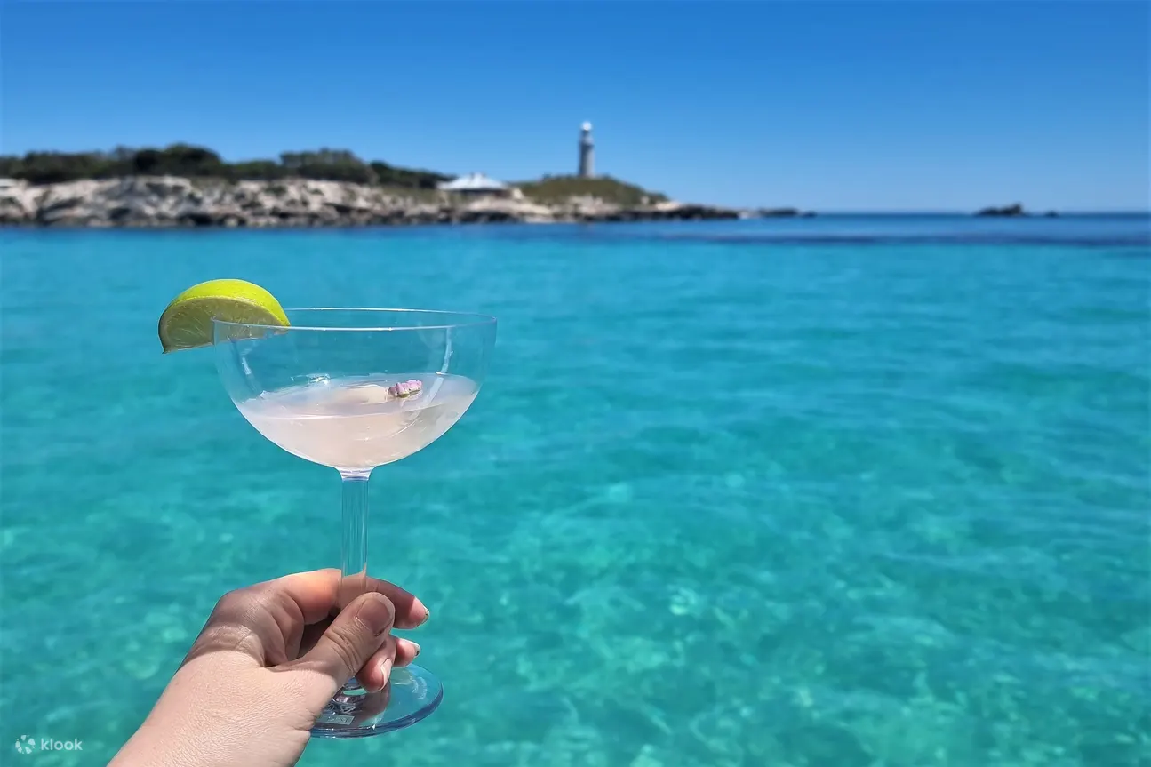 Cocktail overlooking turquoise water on a Rottnest Island luxury seafood cruise