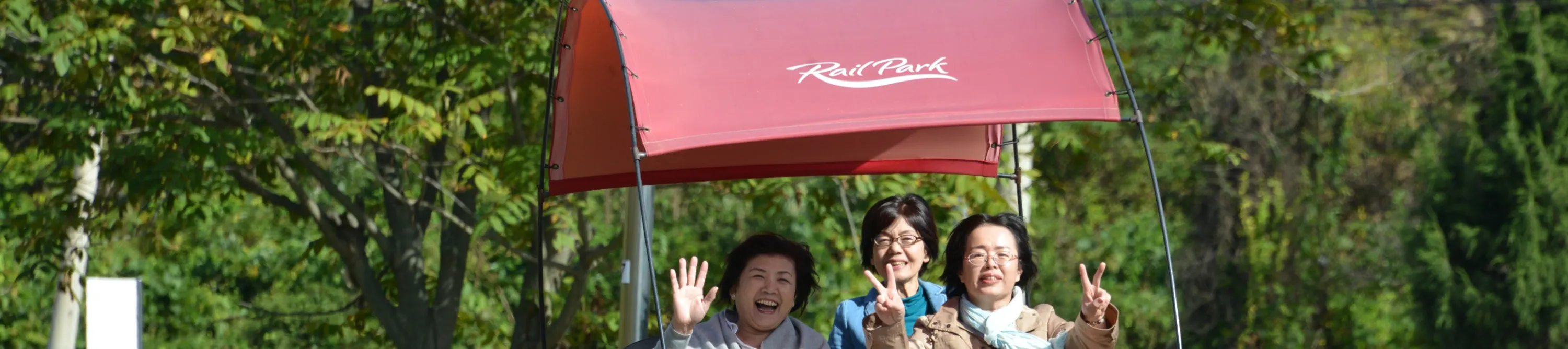 women riding a rail bike smiling