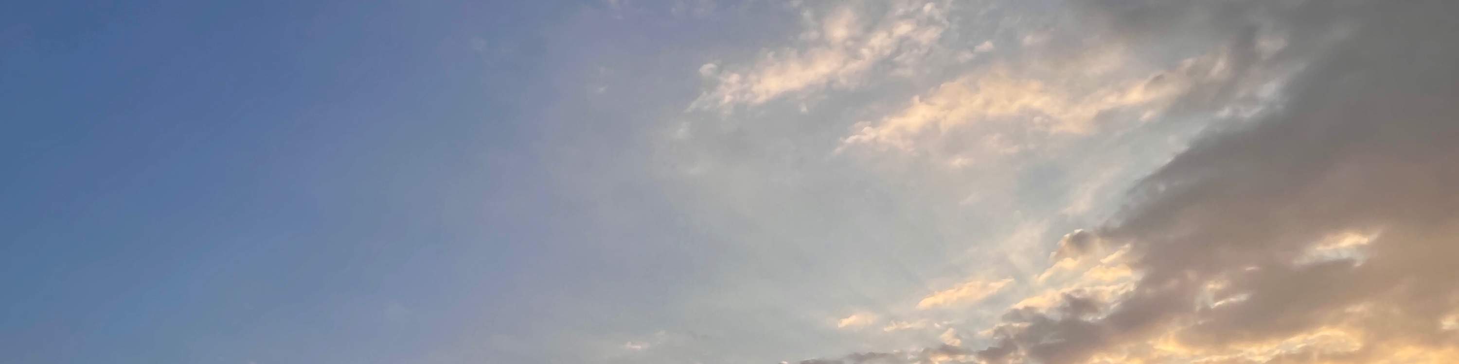 Sunset's lingering glow, the sun slowly descends.