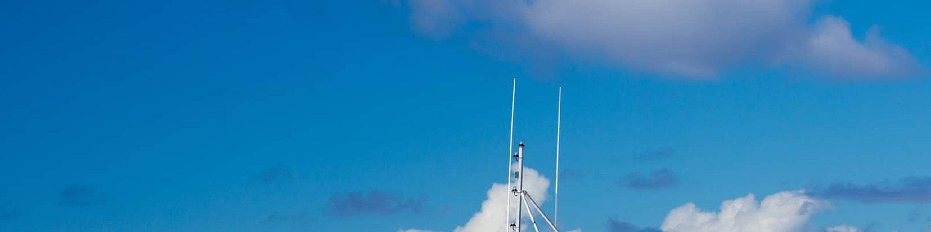 Spirit of Aloha catamaran sailing along the stunning Kona coastline under blue skies