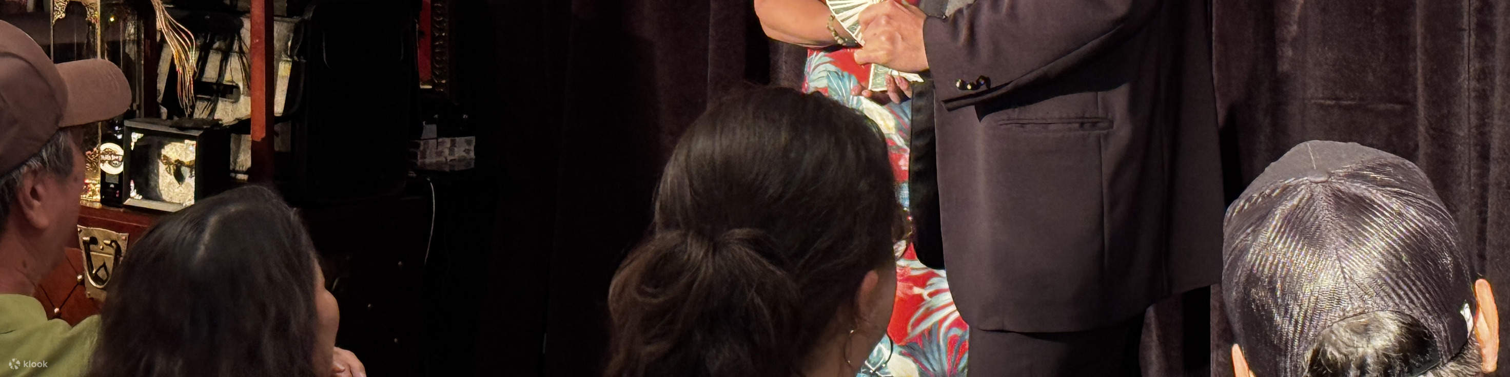 Observe the magician engage a participant in an interactive act filled with mystery and wonder