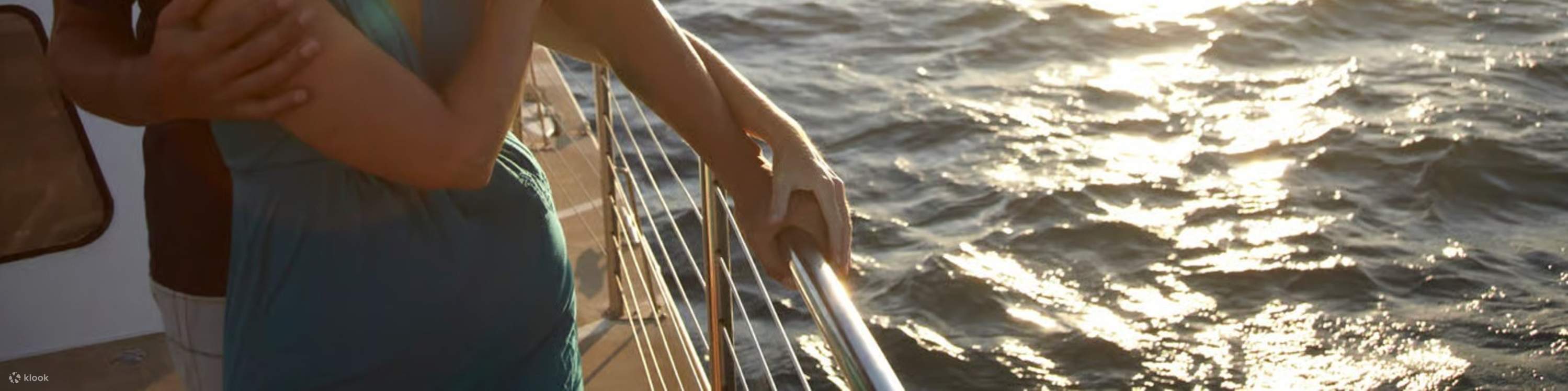 Admire tropical evening glow while a couple shares a quiet sailing moment