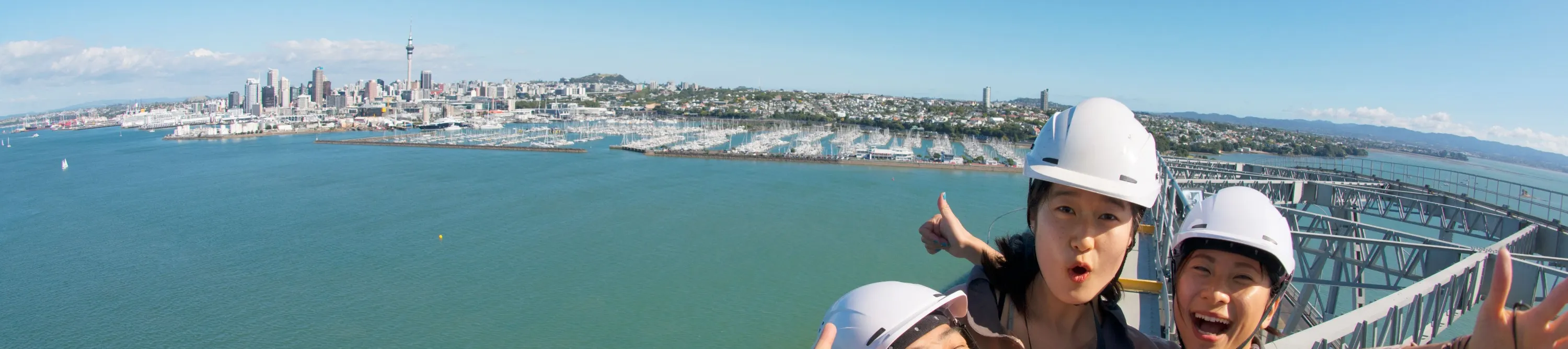 Friends taking selfie on Auckland Harbour Bridge Climb