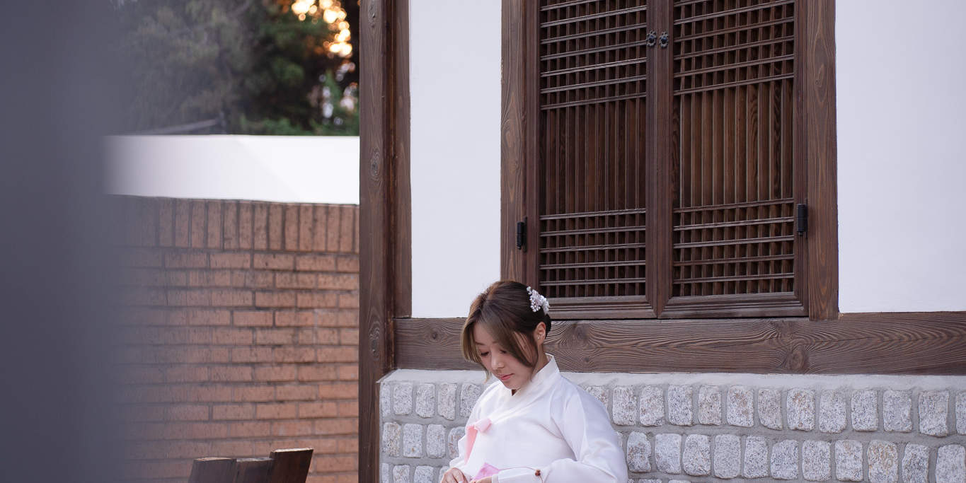 Sesión de hanbok clásico cerca de las puertas tradicionales: la cultura coreana se encuentra con la elegancia.