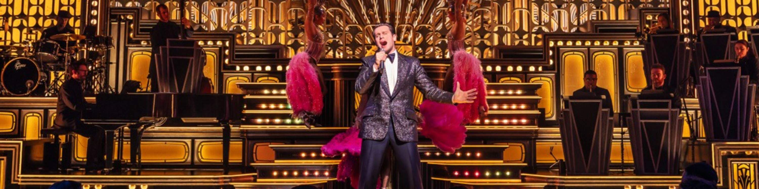 Jonathan Groff dances as Bobby Darin, leading a high-energy number that brings the house down