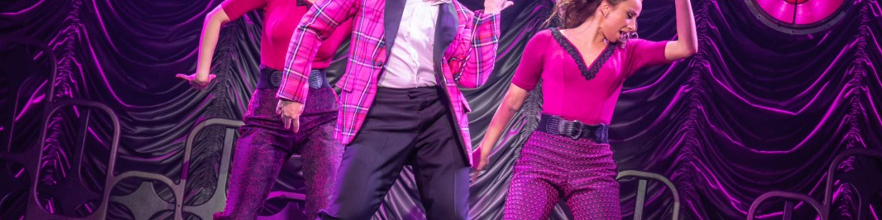 A dazzling dance number lights up the stage, full of swing, rhythm, and vintage flair