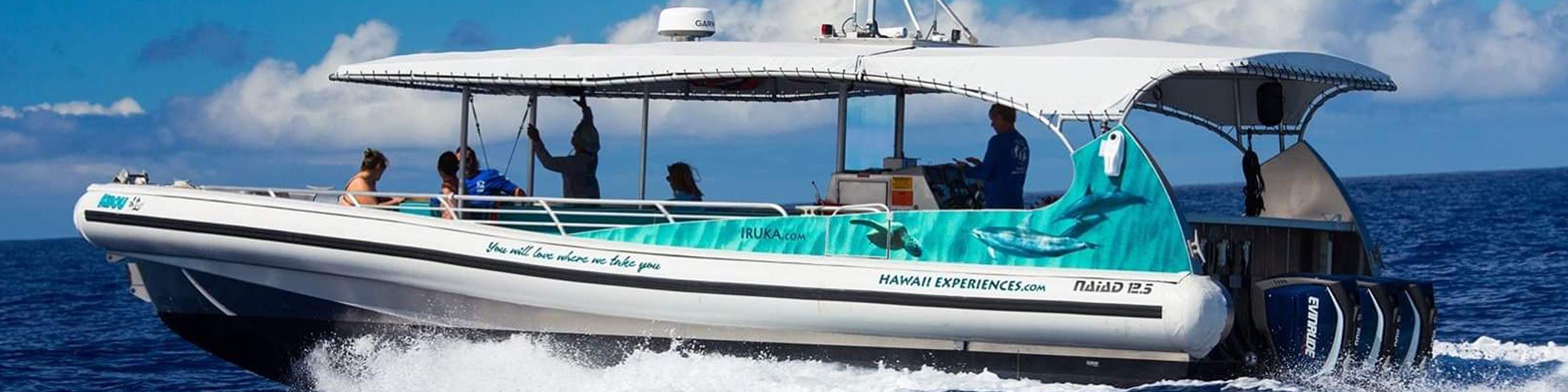 Spirit of Aloha catamaran sailing along the stunning Kona coastline under blue skies