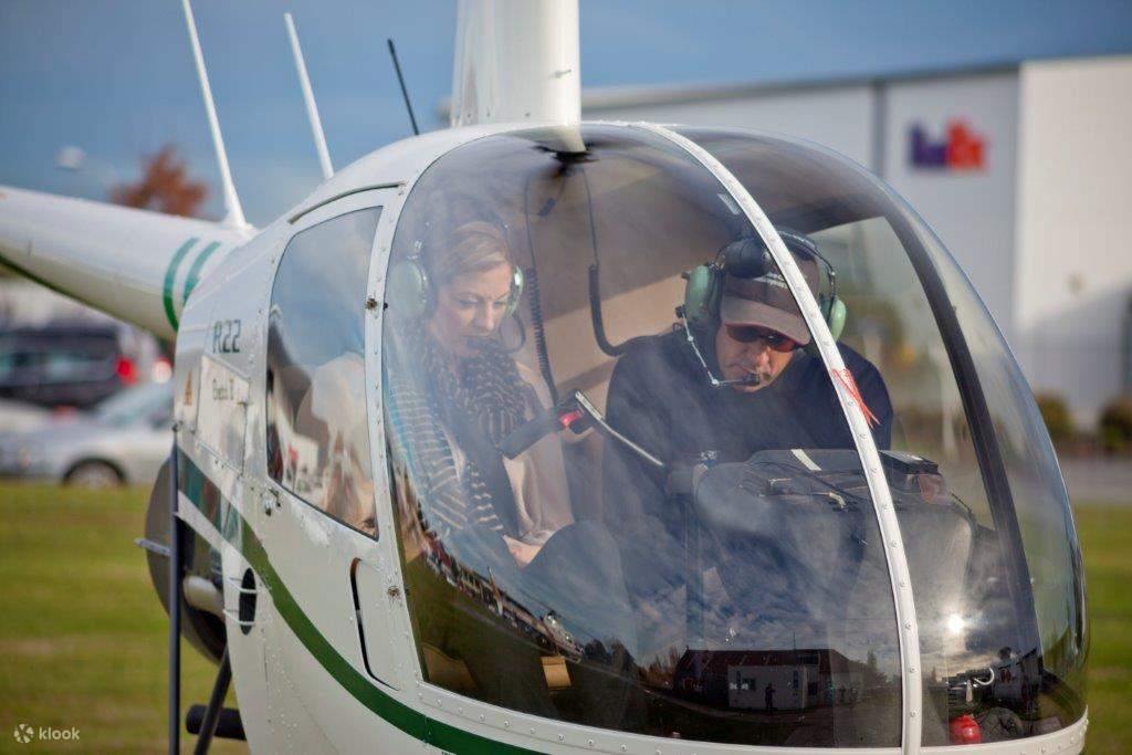 woman and guide inside a helicopter