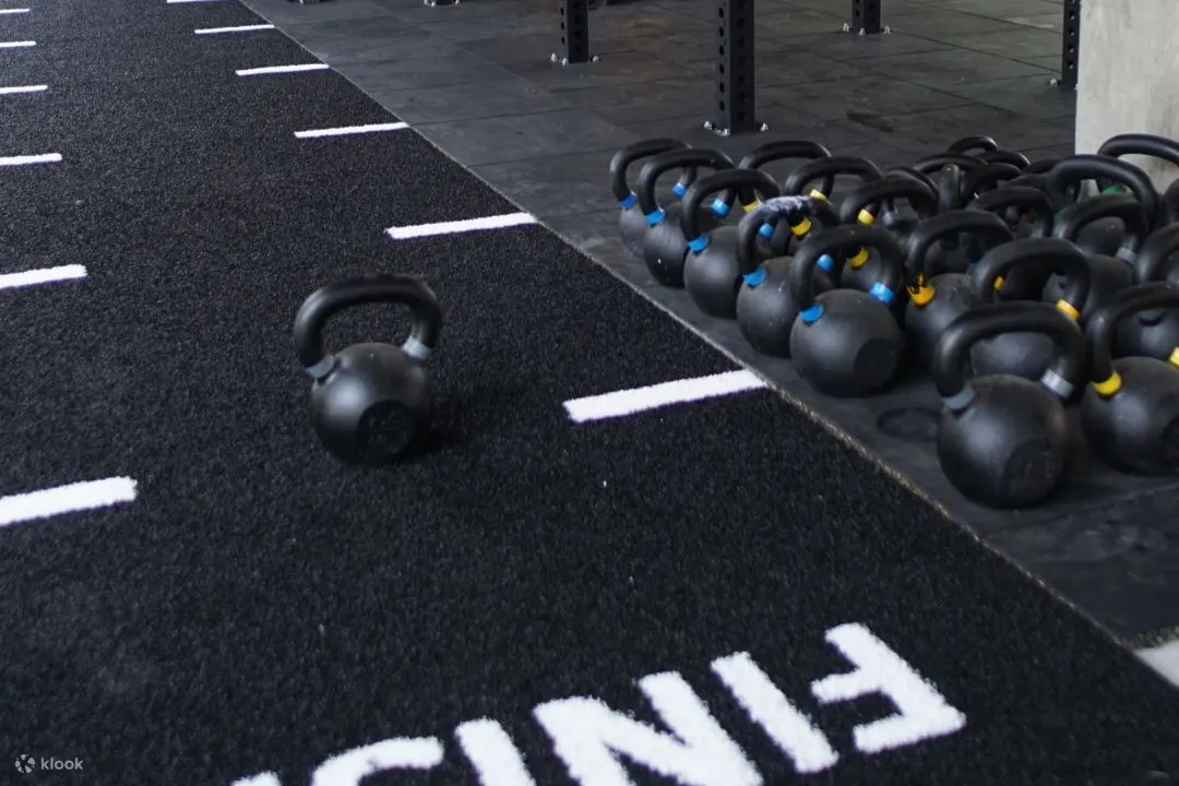 kettle balls on a floor with a finish sign