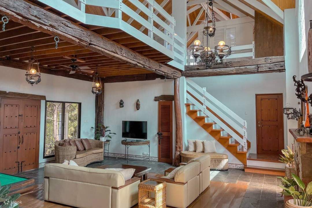 Un salon confortable avec une table de billard et un escalier. Parfait pour se divertir et se détendre entre amis et en famille.