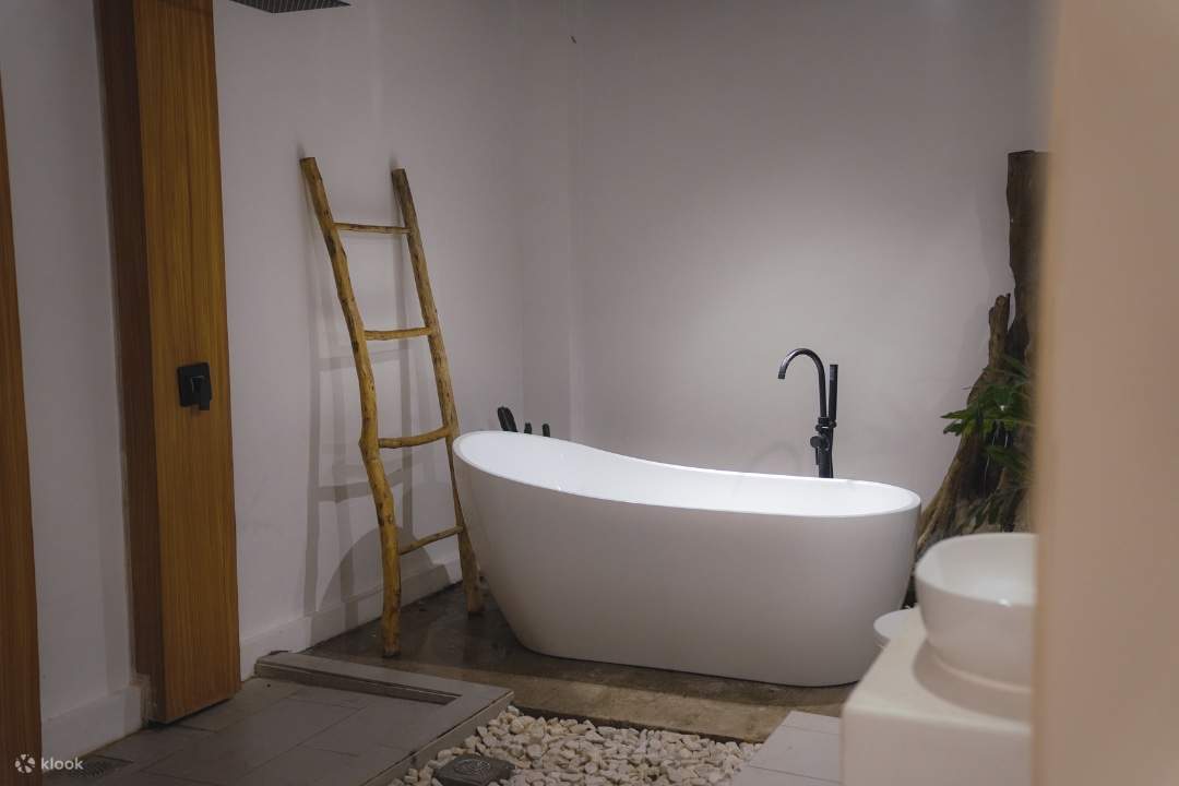 一間配有陶瓷浴缸和梯子的浴室