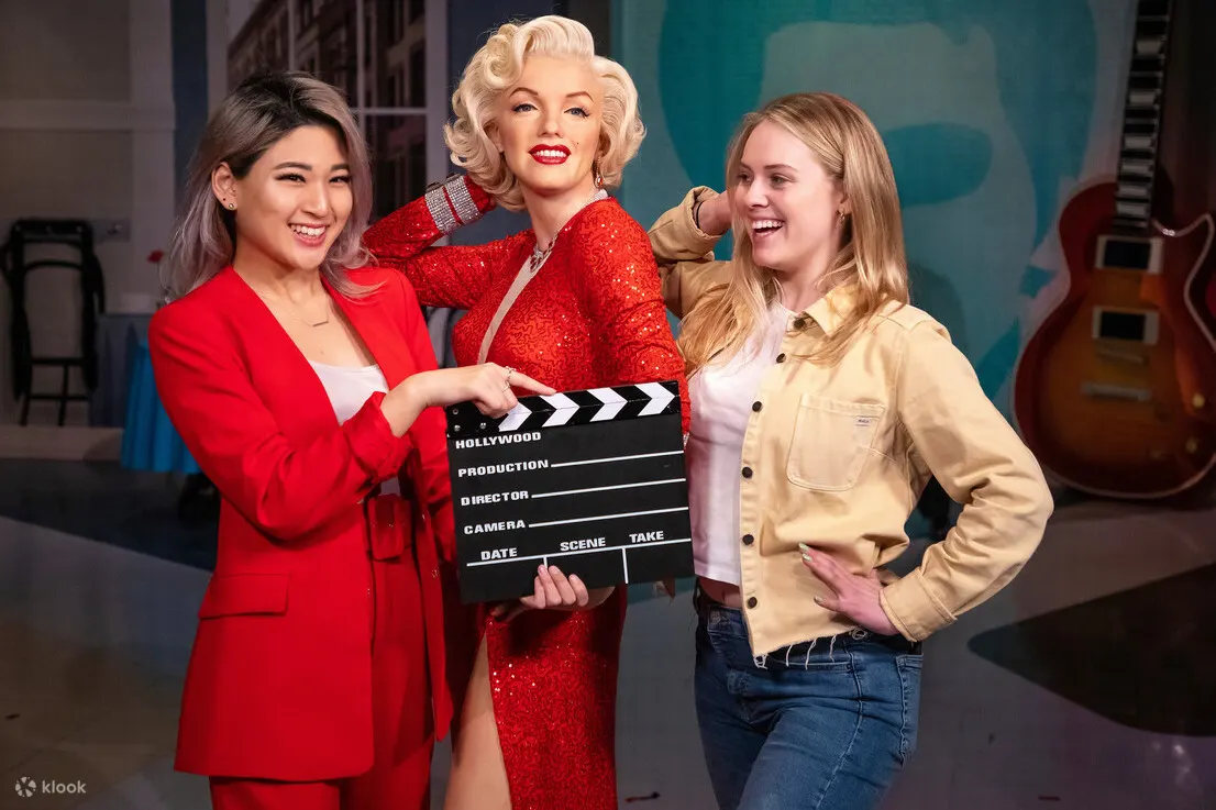 People taking a photo with Marilyn Monroe