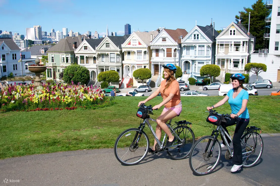 Women cycling near a row of houses