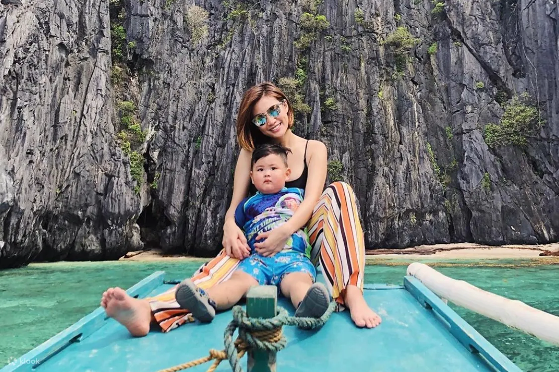 woman and child sitting on a blue raft