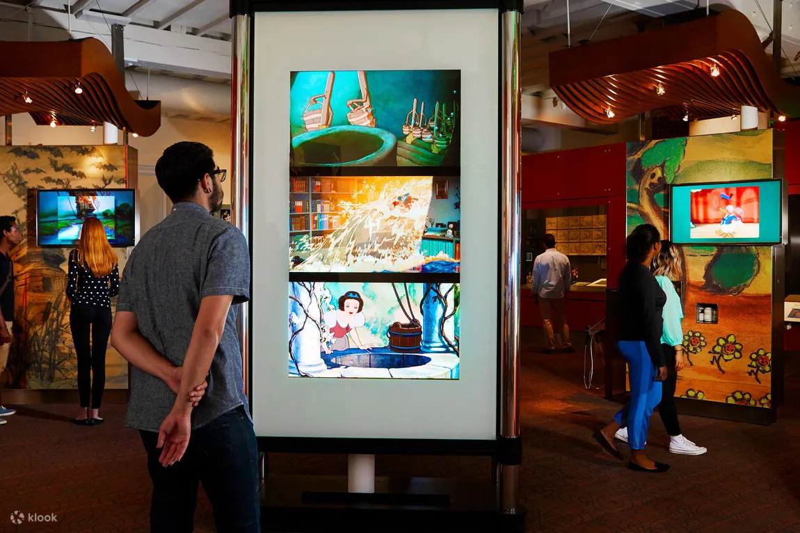 Man looking at a screen with pictures from the Snow White movie