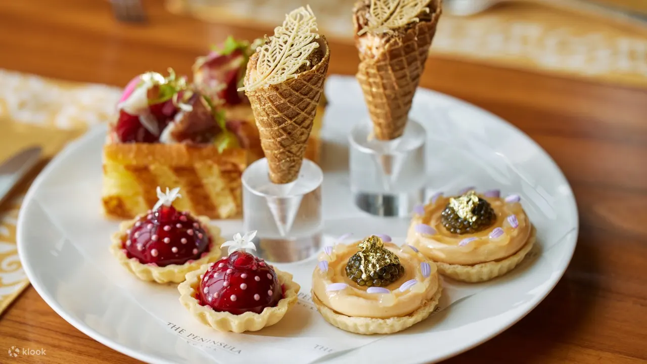 Spend your afternoon lounging by The Peninsula Bangkok's The Lobby with desserts and tea in hand