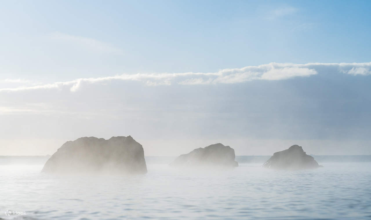 Une brume épaisse obscurcit les rochers de la lagune, ajoutant un côté mystérieux à ce paysage naturel.