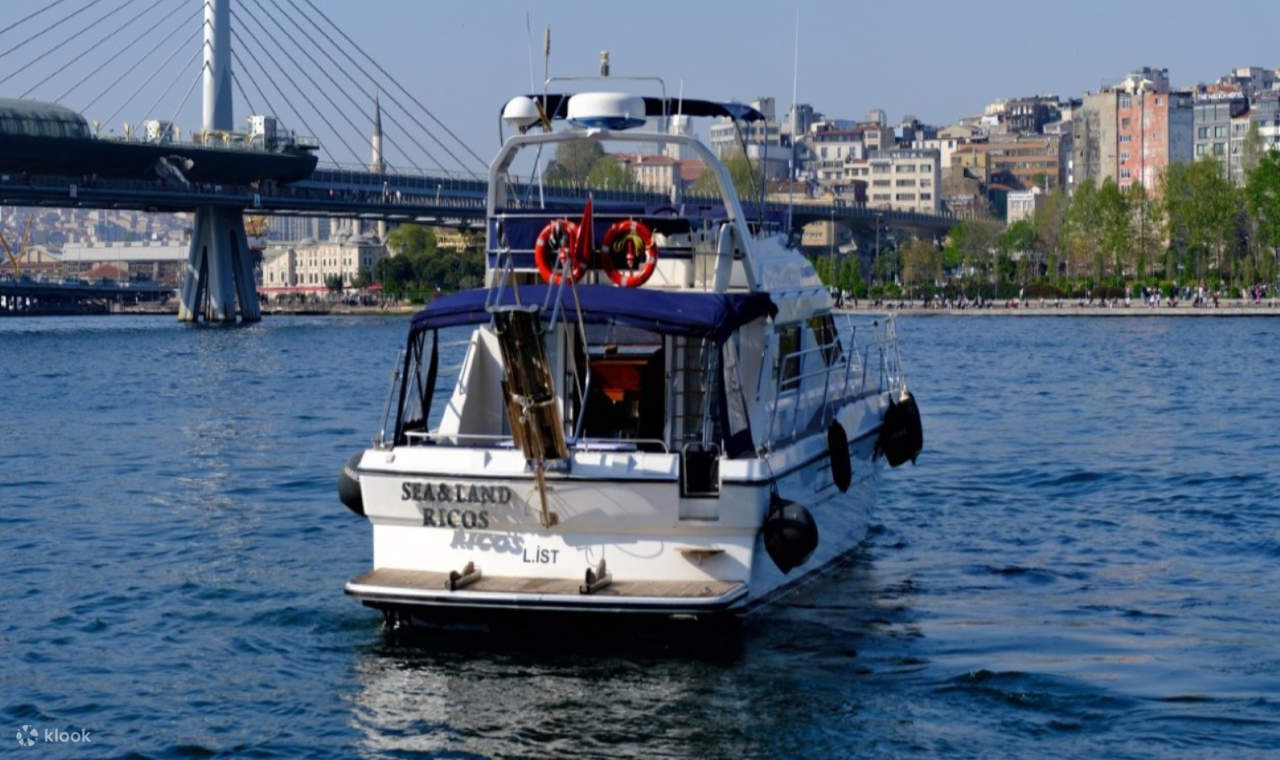 Bersantai di atas dek sambil ombak lembut memantulkan warna keemasan matahari terbenam