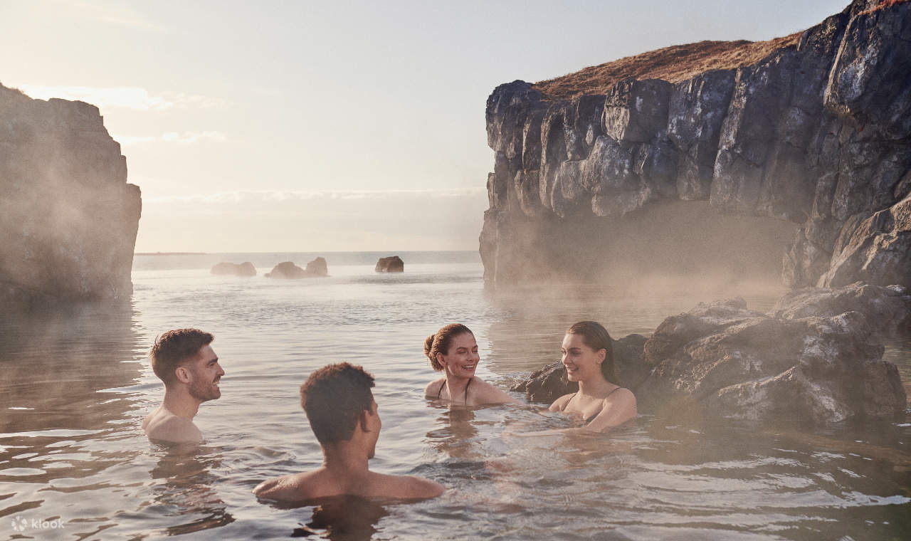 Un gruppo di amici che chiacchierano allegramente mentre si immergono nella calda piscina della laguna