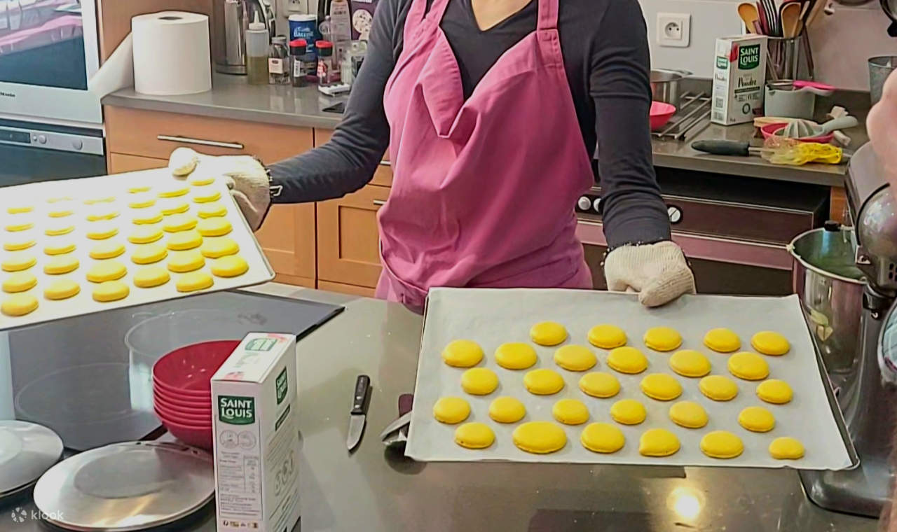 焼き上がったばかりの色とりどりのマカロンが、完璧な丸みを帯びて滑らかに、トレーの上で冷まされています。