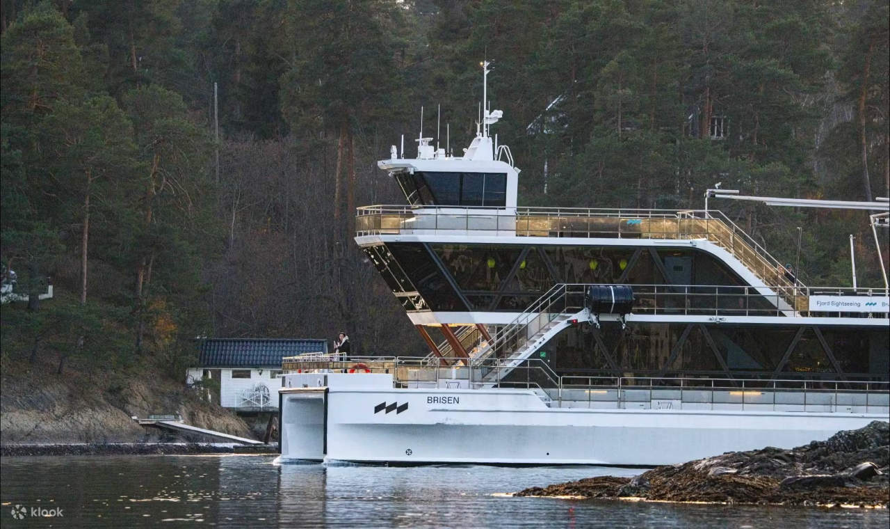 A cruise boat docked calmly at the pier, ready for passengers to board