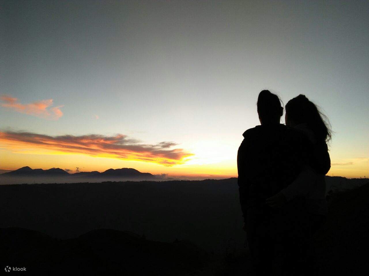 silhouette of a couple against the sunset at mount batur
