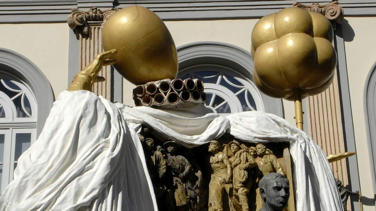 A striking bronze sculpture of Dalí greets visitors at the museum entrance