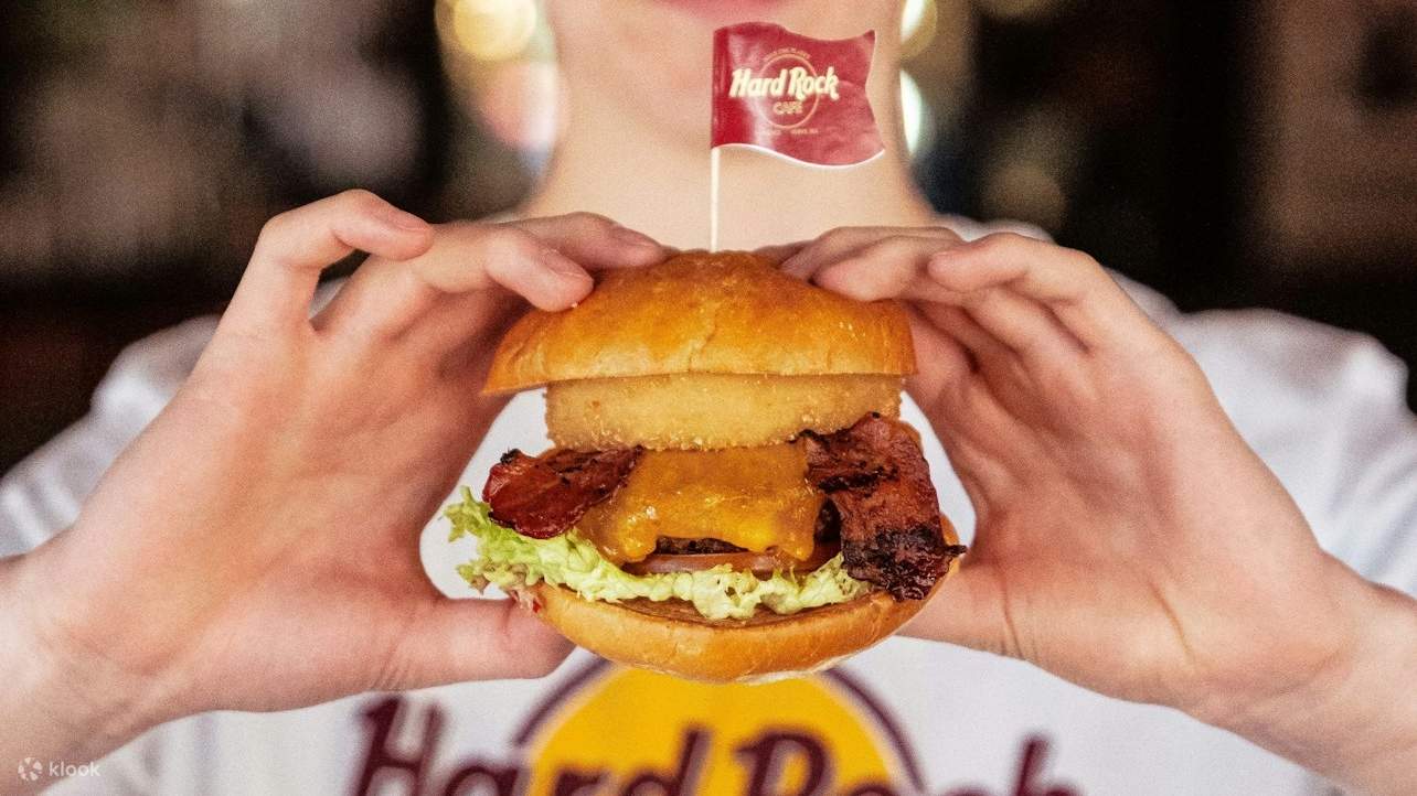 Iconic Hard Rock Cafe burger, stacked high with fresh ingredients and mouthwatering toppings