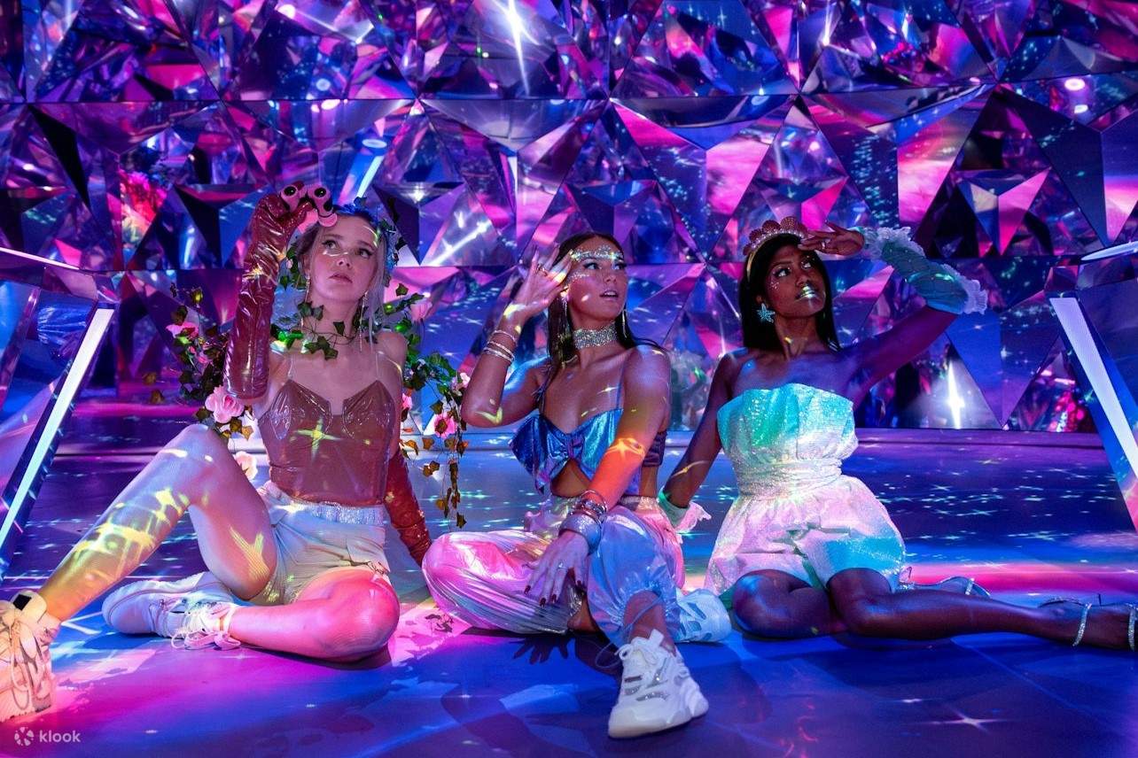 A group of friends are posing in the prism room