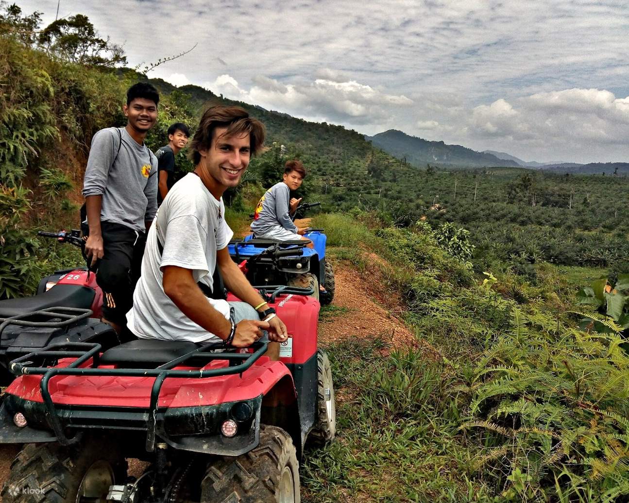 4 pria duduk di ATV mereka di puncak bukit