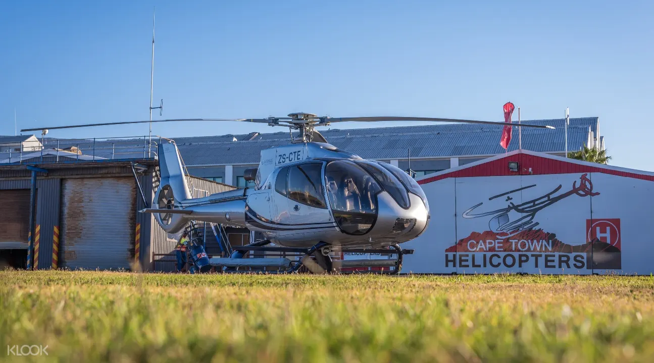 a Cape Town helicopter parked in the middle of a grassy field