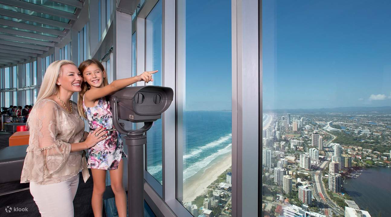 woman and child enjoying view from gold coast observation deck with binoculars