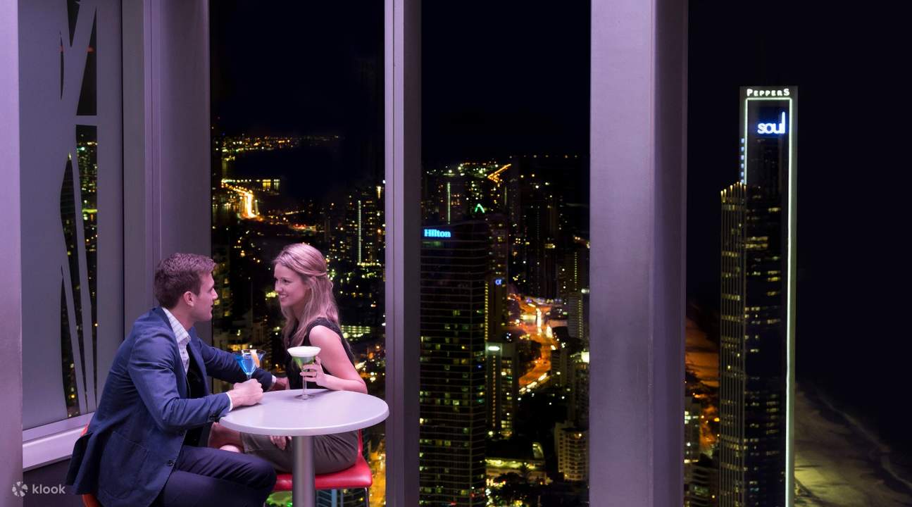 man and woman enjoying drinks at gold coast observation deck bar