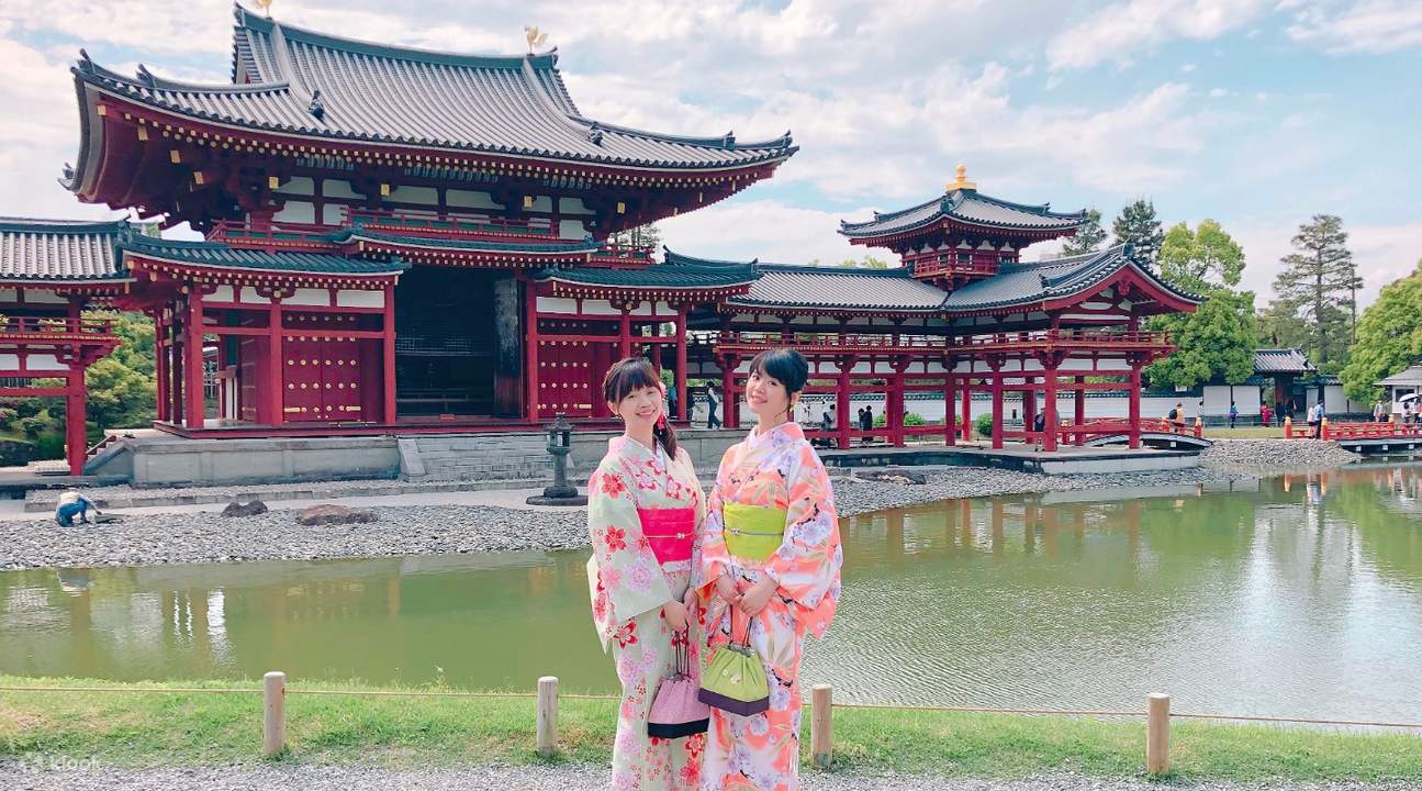 girls wearing kimono posing near temple