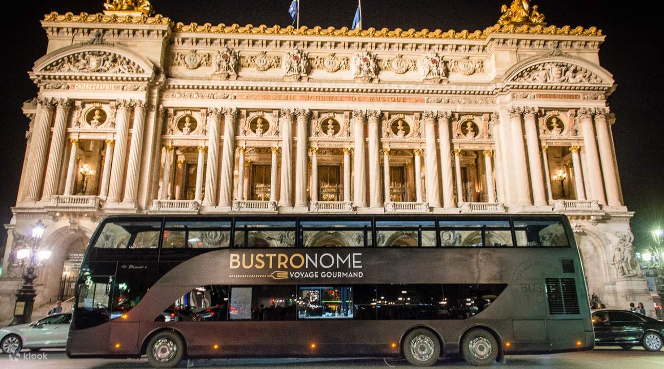 a Bustronome bus in front of a monument