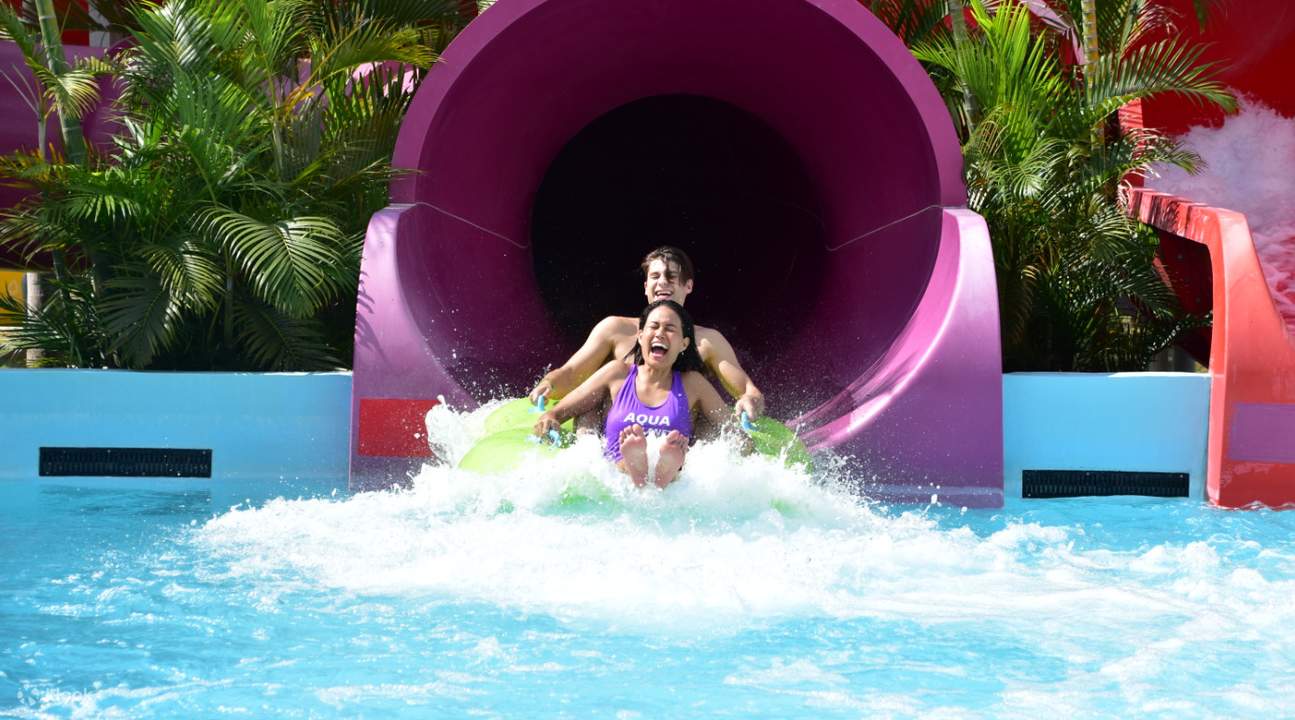 man and woman sliding at aqua planet waterpark