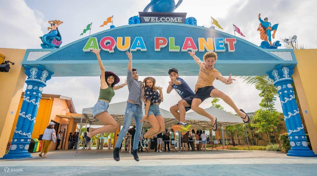 group of friends jump shot at aqua planet entrance