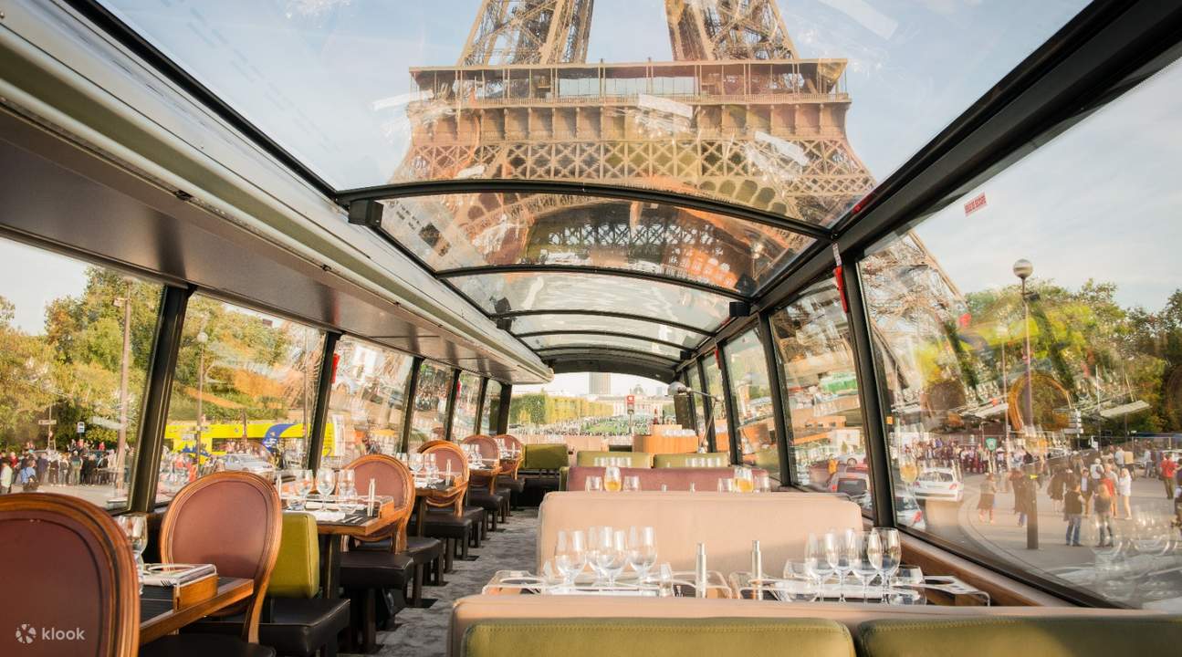 table with glasses and silverware inside the Bustronome bus plus a view of the Eiffel Tower