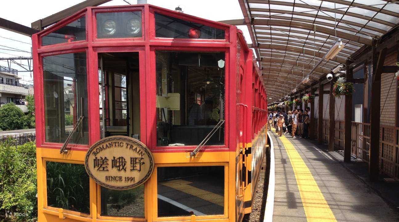 a view of the Sagano Romantic Train and people entering it