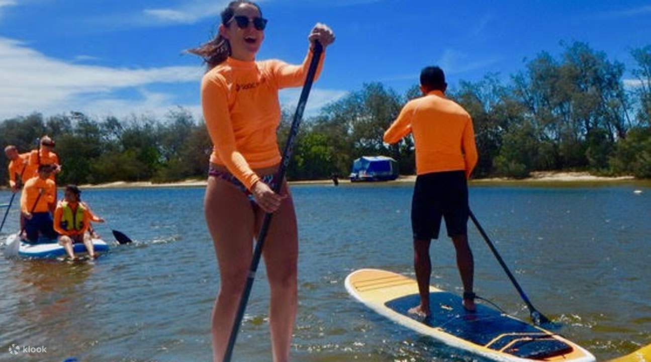 a woman stand up paddleboarding