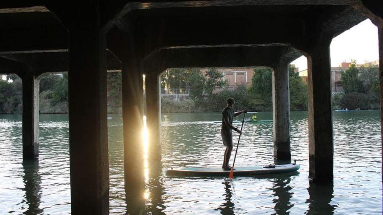 Passa sotto il famoso Ponte di Triana, immergendoti nella vivace atmosfera del lungofiume di Siviglia