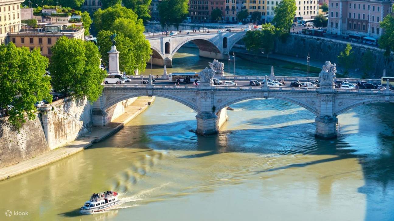 Under the bridge, a boat cruises gently along the calm Tiber River waters